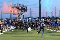 The Fort Campbell Falcons run onto the field before facing the Fort Knox Eagles at Fryar Stadium on Fort Campbell, Ky., for the 50th meeting between the football teams.