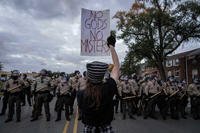 A demonstrator holds a sign