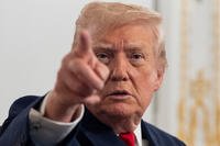 President Donald Trump points at reporters.