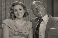 Wanda Maximoff and Vision smiling together in a black-and-white sitcom-style scene from WandaVision. Source: Disney+ / Marvel Studios.
