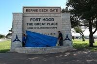 From left, Sohail Salgado, work reception technician, Fort Hood Directorate of Public Works, Operations and Maintenance Division, and Stephen Short, air-conditioning mechanic, DPW, OMD, drop a tarp at the Bernie Beck Gate sign to reveal the new name of the installation during the commemorative renaming ceremony July 28, 2025, at Fort Hood, Texas. (U.S. Army photo by Janecze Wright, Fort Hood Public Affairs)