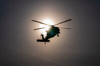 A helicopter in silhouette.