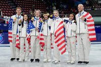 Team USA poses with their gold medals after the figure skating team event at the 2026 Winter Olympics, in Milan, Italy, Sunday, Feb. 8, 2026. (AP Photo/Ashley Landis)