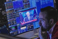 President Donald Trump appears on trader Robert Greason's screen on the floor of the New York Stock Exchange, Friday, Feb. 20, 2026. (AP Photo/Richard Drew)