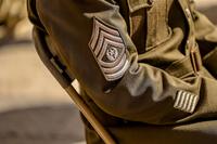 An enlisted soldier's rank insignia on a uniform jacket.