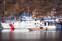 A U.S. Coast Guard 36-foot Special Purpose Craft-Training (SPC-T) boat maneuvers in front of the USCG Cutter Fredrick Mann (WPC1160) in Women's Bay during ARCTIC EDGE 2026 (AE26) at U.S. Coast Guard Air Station Kodiak in Kodiak, Alaska, Feb. 27, 2026. (U.S. Marine Corps photo by Lance Cpl. Thirteen Bahizi)