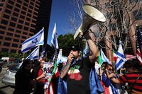 A man speaks through a bull horn during a demonstration in reaction to the U.S. and Israeli strikes on Iran outside the Israeli consulate on Thursday, March 5, 2026, in Los Angeles. (AP Photo/Ryan Sun)