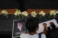 Indian Shiite Muslims write messages in a book of condolences at the Iranian Embassy, for the late Iranian Supreme Leader, Ayatollah Ali Khamenei, in New Delhi, India, Friday, March 6, 2026. (AP Photo/Manish Swarup)