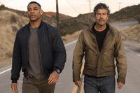 Kyle Chandler and Aaron Pierre walking down a rural road as Hal Jordan and John Stewart in Lanterns. Credit: HBO