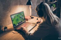 older woman playing games on a laptop