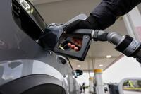 Hand fills up gas tank.