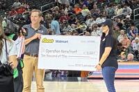 Eric Brewer, VP of Sales for Walmart presents $10,000 check to Rebecca Tayamen, Program Coordinator, Operation Homefront to support military families (Operation Homefront).