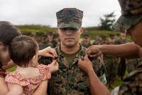 A Marine gets new rank insignia pinned on.