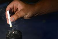 Man stubs out a cigarette. (U.S. Air Force/Airman 1st Class Kimberly Nagle)
