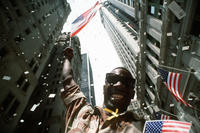 Army Pfc. White waves an American flag while the confetti and tickertape fall on the Welcome Home parade honoring the coalition forces of Desert Storm in New York, June 10, 1991. U.S. Air Force photo by Staff Sgt. Chuck Reger