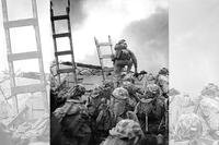 First Lieutenant Baldomero Lopez, USMC, leads the 3rd Platoon, Company A, 1st Battalion, 5th Marines over the seawall on the northern side of Red Beach. (Marine Corps Photo from the collections of the Naval Historical Center)