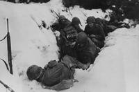 U.S. infantrymen of the 9th Infantry Regiment, 2nd Infantry Division, First U.S. Army, taking shelter from a German artillery barrage during the Battle of Heartbreak Crossroads in the Krinkelter woods, 14 Dec 1944. (Photo: US Army Signal Corps)