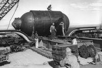 At Alamagordo, N.M., a Manhattan Project team assembles "Jumbo" or "Big Brother" prior to its detonation on July 16, 1945.  