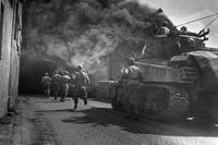 U.S. Third Army runs through smoke-filled streets in Wernberg, Germany. (National Archives photo)