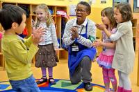 Children enjoy an activity with Strong Beginnings class leader, Carolyn Simms, at the Hainerberg School Age Center. (Karl Weisel/Wiesbaden Family and MWR Marketing)