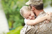 Serviceman hugging daughter