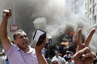 Supporters of Egypt's ousted President Morsi chant slogans against Egyptian Defense Minister Gen. Abdel-Fattah el-Sissi during clashes with Egyptian security forces in Cairo's Mohandessin neighborhood, Egypt,, Aug. 14, 2013. (AP Photo/Hassan Ammar