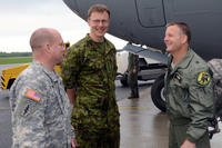 Caption: Col. Jaak Tarien (center), commander of the Estonian air force, greets Army and Air Force officials after they arrive at Amari Air Base, Estonia on May 31, 2013 for an exercise. (U.S. Air Force)