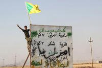 In this Monday, Sept. 1, 2014 file photo, a member of Iraq's Hezbollah Brigade holds their flag during an operation outside Amirli, some 105 miles (170 kilometers) north of Baghdad, Iraq. (AP Photo, File)