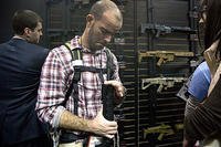 Will Michael of Homer, La., examines a Bushmaster M4 A3 Carbine 300 AAC Blackout rifle at the Bushmaster exhibit during the Shooting Hunting Outdoor Tradeshow, Tuesday, Jan. 15, 2013, in Las Vegas.