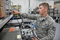 Staff Sgt. Alexander Rex, the 379th Expeditionary Maintenance Squadron avionics intermediate systems team leader from Fargo, N.D., tests an ultra-high frequency radio transmitter at Al Udeid Air Base, Qatar. (U.S. Air Force/Tech. Sgt. James Hodgman)
