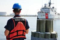 A Coast Guard member waits on the pier for the Coast Guard Cutter Tampa at Base Portsmouth, Virginia, April 27, 2016. (Photo: Petty Officer 1st Class Melissa Leake)