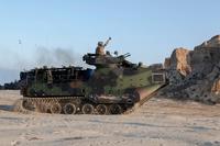 A Marine signals to move forward in an amphibious assault vehicle (AAV) during an amphibious landing for Exercise Dawn Blitz 2015. (U.S. Navy / Mass Communication Specialist 2nd Class Ryan Riley)