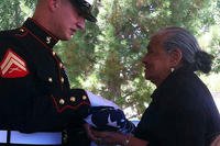 The flag is presented at Manuel Castano's funeral.
