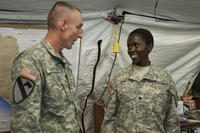 Army Maj. Gen. Gary Volesky recognizes Army Spc. Rysper Sirma for her exemplary performance while supporting Operation United Assistance at the Barclay Training Center, Monrovia, Liberia, Dec. 26, 2014. (U.S. Army photo by Staff Sgt. V. Michelle Woods)