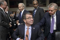 Ashton Carter, President Obama’s choice to be defense secretary, is greeted by Sen. Lindsey Graham during a break in Carter's testimony before the Senate Armed Services Committee (AP Photo/J. Scott Applewhite)