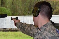 Second Lt. Tucker Sears, the 436th Logistics Readiness Squadron material management officer in charge, shoots a .22-caliber pistol during Team Camp March 24, 2015, at Fort Benning, Ga. (U.S. Air Force/Lt. Col. Hugh M. Ragland)