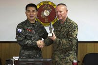 Lt. Gen. Larry Nicholson, the commanding general of III Marine Expeditionary Force, right, presents Lt. Gen. Sang Hoon Lee, commandant of the of the Republic of Korea Marine Corps, left, with a gift Dec. 11, 2015. (Photo: Cpl. Abbey Perria)