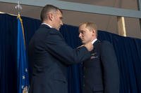 Lt.Col. James Mach pins the rank of captain onto Capt. Norman Popp during a 376th Air Expeditionary Wing promotion and awards ceremony. (U.S. Air Force photo/Staff Sgt. Robert Barnett)
