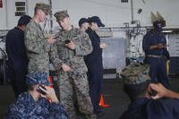 Marines and Sailors with the 15th Marine Expeditionary Unit and Sailors with America Amphibious Ready Group received an opportunity to talk to family using their mobile phones aboard USS America, Aug. 24, 2017. (U.S. Marine Corps photo/Jacob Pruitt)