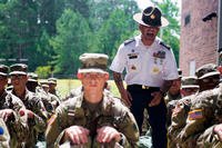 U.S. Army Drill Sergeant Staff Sgt. Avila assigned to Foxtrot 1st Battalion 34th Infantry Regiment directs trainees on the First day of Basic Combat Training on June 12, 2017 at Fort Jackson, SC. (U.S. Army photo/Spc. Darius Davis)