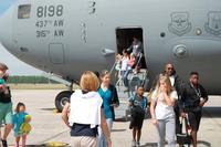Some of the approximately 700 family members eventually to arrive at NAS Pensacola as part of Hurricane Matthew evacuation from Naval Station Guantanamo Bay depart their aircraft. (U.S. Navy photo by Cathy Whitney)