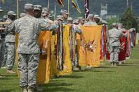 FILE -- Commanders of the 2nd Armored Brigade Combat Team, 1st Cavalry Division, uncase their unit's colors for the first time in South Korea during a transfer of authority at Camp Casey, July 13, 2015. (U.S. Army / Staff Sgt. John Healy)