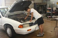 Engine repair in white car.