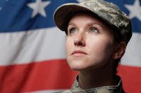 Female veteran in front of an American flag.