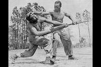 Cpl. Alvin "Tony" Ghazlo, the senior bayonet and unarmed combat instructor at Montford Point, demonstrates a disarming technique on his assistant, Private Ernest "Judo" Jones. (U.S. Marine Corps)