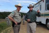 In this image released June 3, 2016, law enforcement officials at Fort Hood discuss the search operations for four soldiers missing after their truck overturned in a rain-swollen creek. Five soldiers died in the incident. (U.S. Army photo)
