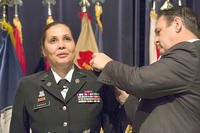 Davis Tindoll Jr., Atlantic Region Director of the U.S. Army Installation Management Command, pins the rank of colonel on the shoulders of Picatinny Arsenal garrison commander, Col. Ingrid Parker. (U.S. Army/Todd Mozes)