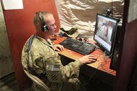 A soldier meets his baby over Skype. (Staff Sgt. Elvis Umanzor/U.S. Army)