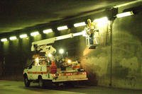 Electrician performing maintenance in a tunnel.
