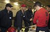 Electrician's Mate 1st Class Michael McFadden speaks with Professional Apprenticeship Career Tracks (PACT) sailors during a job mentorship fair on the USS Gerald R. Ford.